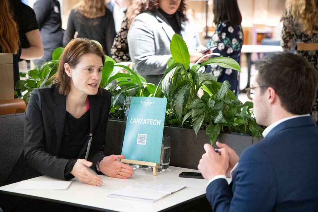 Freya Burton (LanzaTech) talks with advisors and potential investors at the Deloitte networking event