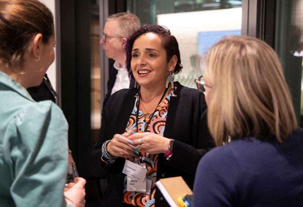 Larissa Hale (Queensland Indigenous Womens Ranger Network) talks with advisors at the Deloitte networking event