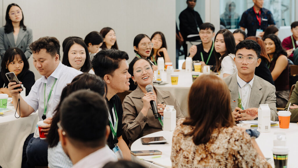 A youth programme attendee asking a question during a masterclass